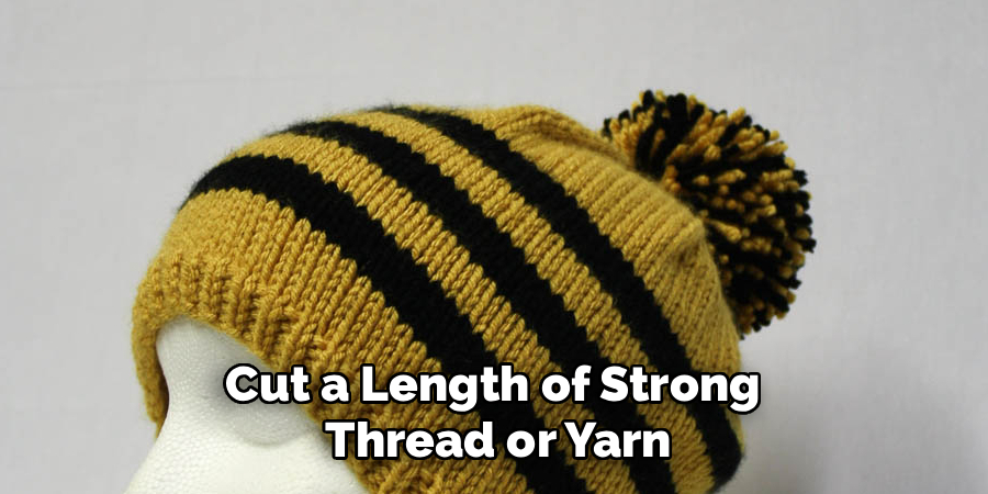 Cut a Length of Strong
Thread or Yarn